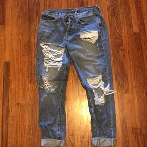 Ripped up button fly boyfriend fit jeans